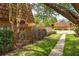 Exterior view of the townhome showcasing the lush landscaping and the beautiful lush green grass at 5251 Brook Ct # 242, Orlando, FL 32811