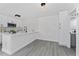 Modern white kitchen featuring a peninsula, undermount sink, and stainless steel appliances at 5251 Brook Ct # 242, Orlando, FL 32811