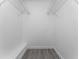 Walk-in closet features neutral walls, wood floors and shelving racks at 5251 Brook Ct # 242, Orlando, FL 32811