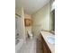 Bathroom with tiled shower and floors, vanity, and toilet at 6169 Metrowest Blvd # 208, Orlando, FL 32835