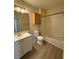 Well-lit bathroom with a modern vanity, wood look flooring, and a shower-tub combination at 6169 Metrowest Blvd # 208, Orlando, FL 32835