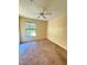 Cozy bedroom with a ceiling fan and natural light from the window, creating a relaxing space at 6169 Metrowest Blvd # 208, Orlando, FL 32835