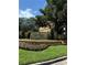 Serenata condo residences sign with manicured landscaping and colorful flowers at 6169 Metrowest Blvd # 208, Orlando, FL 32835