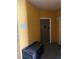 Condo hallway with unit 208 entrance and storage bench at 6169 Metrowest Blvd # 208, Orlando, FL 32835