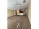 Open-concept living area with carpet floors, ceiling fan, and view to the kitchen area at 6169 Metrowest Blvd # 208, Orlando, FL 32835
