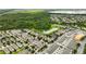 Aerial view of a community surrounded by trees and a body of water at 6834 Habitat Dr, Harmony, FL 34773