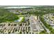 Community aerial view with pond, green spaces and well-manicured lawns at 6834 Habitat Dr, Harmony, FL 34773