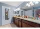 This bathroom features dual sinks, a tub/shower combo, granite counters, and great lighting at 6834 Habitat Dr, Harmony, FL 34773