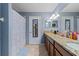 This bathroom features a long vanity, granite counters, a shower/tub, and tiled floors at 6834 Habitat Dr, Harmony, FL 34773
