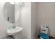 Small half-bathroom features pedestal sink and toilet at 6834 Habitat Dr, Harmony, FL 34773