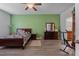 This cozy bedroom features hardwood floors, a ceiling fan, and a full size bed at 6834 Habitat Dr, Harmony, FL 34773
