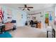This bonus room has carpet, a ceiling fan, a desk, and great natural light at 6834 Habitat Dr, Harmony, FL 34773