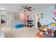 This bonus room has carpet, a ceiling fan, and great natural light at 6834 Habitat Dr, Harmony, FL 34773