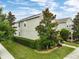 A beautiful two-story home showcasing lush landscaping and mature trees at 6834 Habitat Dr, Harmony, FL 34773