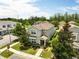 Two-story home in a landscaped neighborhood with mature trees, and a well-maintained lawn at 6834 Habitat Dr, Harmony, FL 34773
