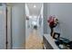 Long hallway features beige-tiled flooring, neutral-colored walls, and minimal decorations at 6834 Habitat Dr, Harmony, FL 34773