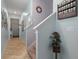 Hallway features beige-tiled flooring, neutral-colored walls, and decorative accents at 6834 Habitat Dr, Harmony, FL 34773
