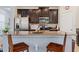 Modern kitchen with stainless steel appliances, granite countertops, and dark wood cabinetry at 6834 Habitat Dr, Harmony, FL 34773