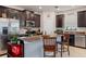 Modern kitchen with stainless steel appliances, granite countertops, and dark wood cabinetry and tile flooring at 6834 Habitat Dr, Harmony, FL 34773