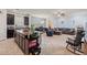 Open-concept living space with kitchen island, comfortable seating and tile flooring throughout at 6834 Habitat Dr, Harmony, FL 34773