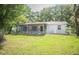 Backyard view of house with screened patio at 7410 Orange Crest Cir, Lakeland, FL 33810