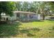 Backyard view of house with screened patio and lawn at 7410 Orange Crest Cir, Lakeland, FL 33810