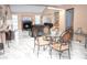 Open concept living and dining area with fireplace, sleek tile floors, and ample natural light at 7410 Orange Crest Cir, Lakeland, FL 33810