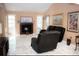 Bright living room with a cozy fireplace, large windows, and a neutral color palette at 7410 Orange Crest Cir, Lakeland, FL 33810