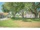 Expansive yard with lush green grass and mature trees, providing ample outdoor space at 7410 Orange Crest Cir, Lakeland, FL 33810