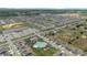 Aerial view of a sprawling neighborhood with a community pool, a retail store, and neatly arranged homes at 757 Citrus Reserve Blvd, Davenport, FL 33837