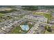 Bird's eye view of a residential community featuring a pool, retail, and modern homes against a green wooded backdrop at 757 Citrus Reserve Blvd, Davenport, FL 33837