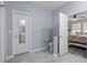 Light and open bathroom with a doorway to the main bedroom, next to the toilet at 757 Citrus Reserve Blvd, Davenport, FL 33837