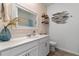 Bright bathroom featuring a large mirror, white vanity, and under cabinet storage at 757 Citrus Reserve Blvd, Davenport, FL 33837
