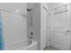 Bathroom with white tiled shower/tub combo and white walls at 757 Citrus Reserve Blvd, Davenport, FL 33837