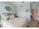 Bedroom featuring soft mint walls, closet, and accent mirror above the bed at 757 Citrus Reserve Blvd, Davenport, FL 33837