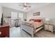 Bright bedroom featuring bed, dressers, ceiling fan, treadmill, and bright natural light at 757 Citrus Reserve Blvd, Davenport, FL 33837