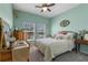 Cozy bedroom featuring mint green walls, carpet, and antique furniture at 757 Citrus Reserve Blvd, Davenport, FL 33837