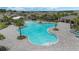 Aerial view of a sparkling blue community pool surrounded by palm trees, lounge chairs, and manicured landscaping at 757 Citrus Reserve Blvd, Davenport, FL 33837