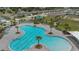 Overhead view of a resort-style community pool with palm trees, lounge chairs, and a playground for residents to enjoy at 757 Citrus Reserve Blvd, Davenport, FL 33837