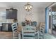 Inviting dining area featuring a modern chandelier and seamless connection to the kitchen at 757 Citrus Reserve Blvd, Davenport, FL 33837