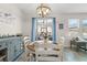 Dining area with table, chairs, and sideboard, next to large window and doors to the outside at 757 Citrus Reserve Blvd, Davenport, FL 33837