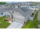 Attractive single-story home with neutral-toned exterior, two-car garage, and professionally landscaped front yard at 757 Citrus Reserve Blvd, Davenport, FL 33837