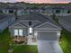 Charming single-Gathering home featuring a well-manicured lawn, two-car garage, and welcoming front entrance at 757 Citrus Reserve Blvd, Davenport, FL 33837
