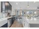 Open-concept kitchen with stainless steel appliances, white countertops, and seamless connection to the dining area at 757 Citrus Reserve Blvd, Davenport, FL 33837