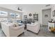 Bright living room featuring a ceiling fan, two sofas, an arm chair, and built-in shelving units at 757 Citrus Reserve Blvd, Davenport, FL 33837