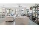 Open-concept living room with dining area featuring wood-look tile flooring and light-colored furniture at 757 Citrus Reserve Blvd, Davenport, FL 33837