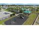 Community playground with a covered picnic area and a pool in the background, offering a Gathering-friendly amenity at 757 Citrus Reserve Blvd, Davenport, FL 33837
