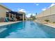 Inviting backyard pool features a modern design with a waterfall feature and ample seating for relaxation at 757 Citrus Reserve Blvd, Davenport, FL 33837
