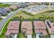 An aerial view shows the terracotta roofs of new homes in a planned community at 7622 Oakmoss Loop, Davenport, FL 33837