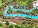 An aerial view of the community's lazy river meandering through palm trees at 7622 Oakmoss Loop, Davenport, FL 33837